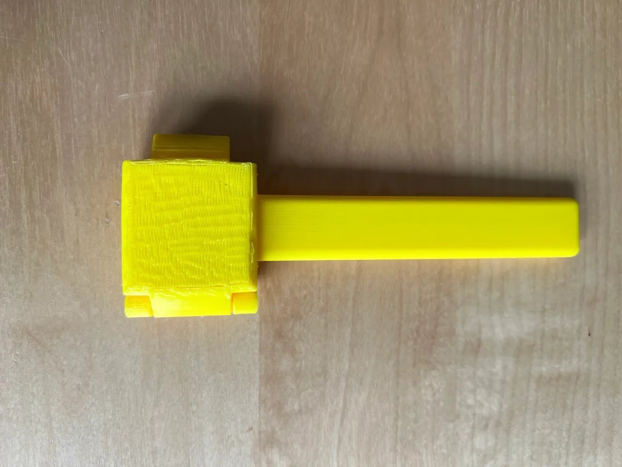 a yellow object on a wooden surface