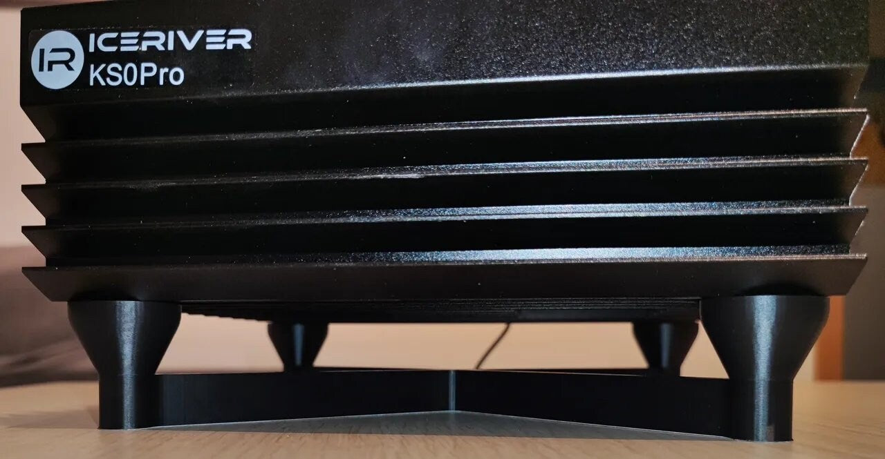 a black object sitting on top of a wooden table