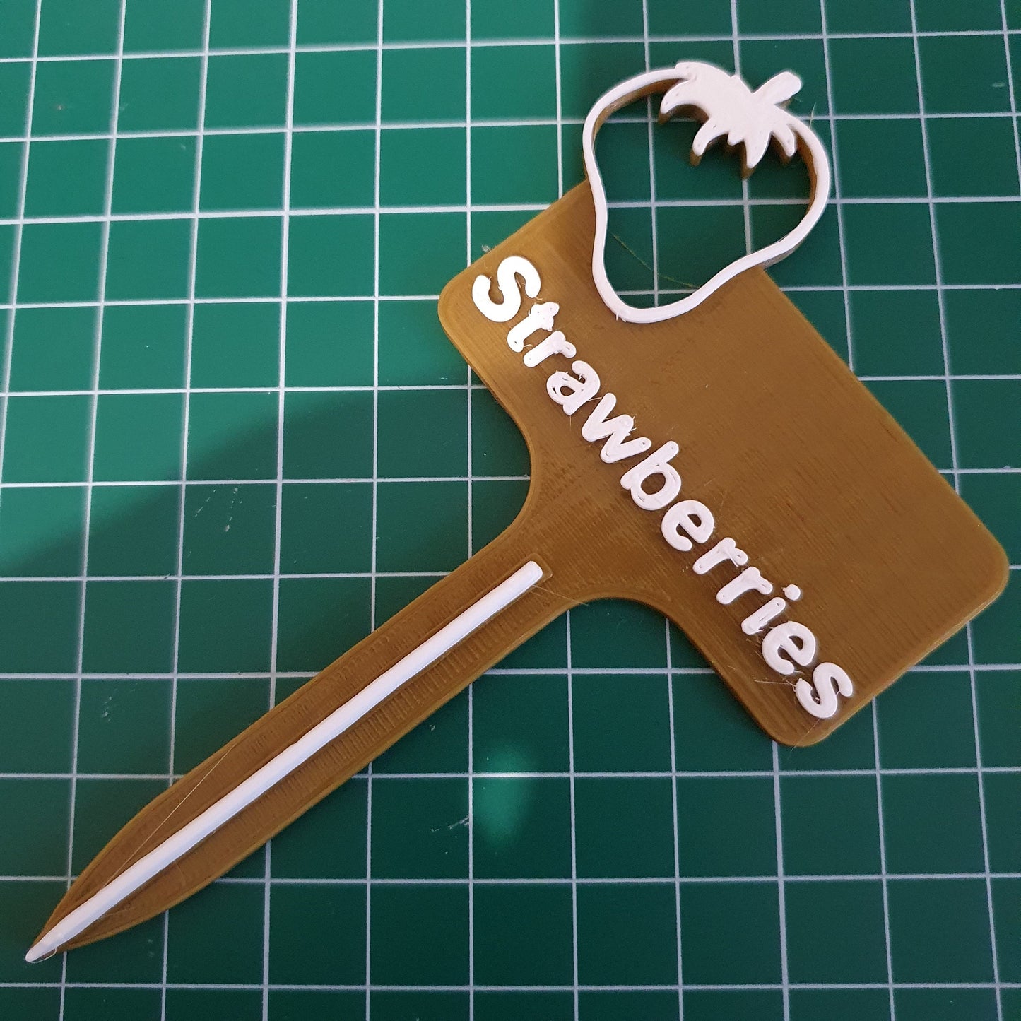 a picture of a wooden spatula with the words strawberries on it