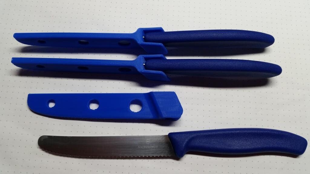 three blue plastic knives with holes in them