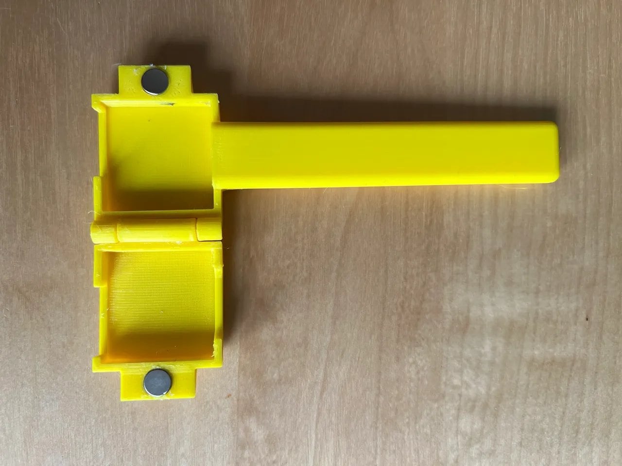 a close up of a yellow object on a wooden surface