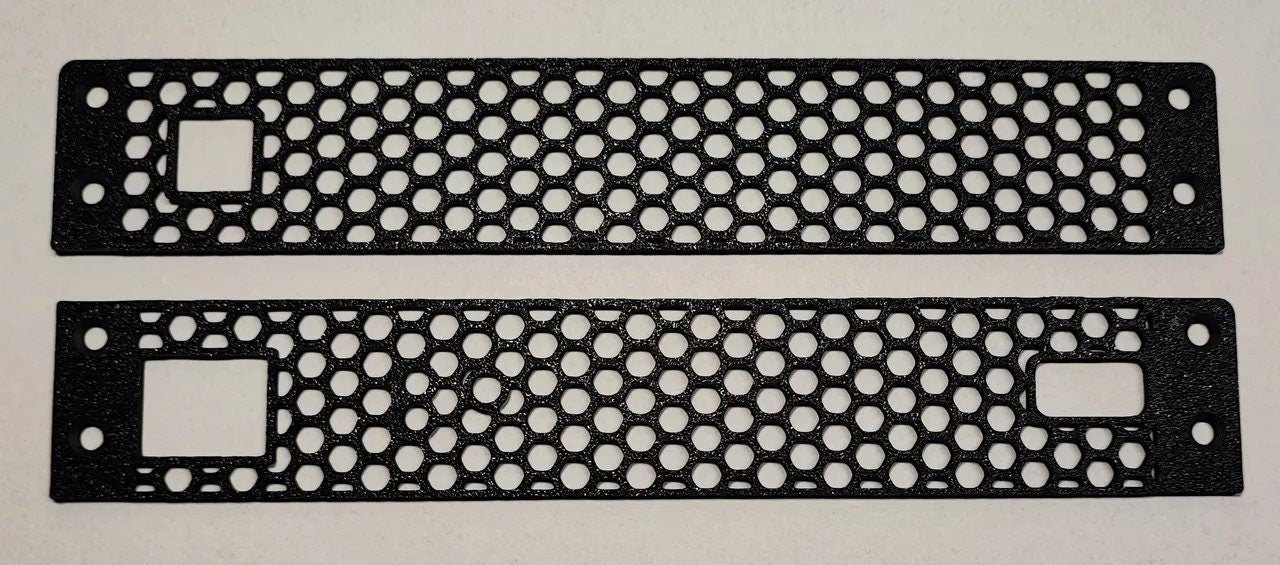 a pair of black metal license plates on a white surface