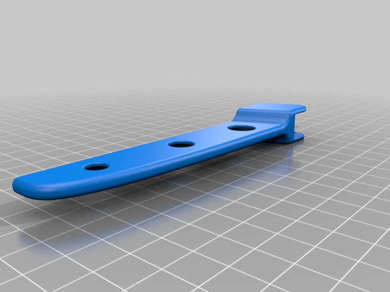 a blue plastic object sitting on top of a tiled floor
