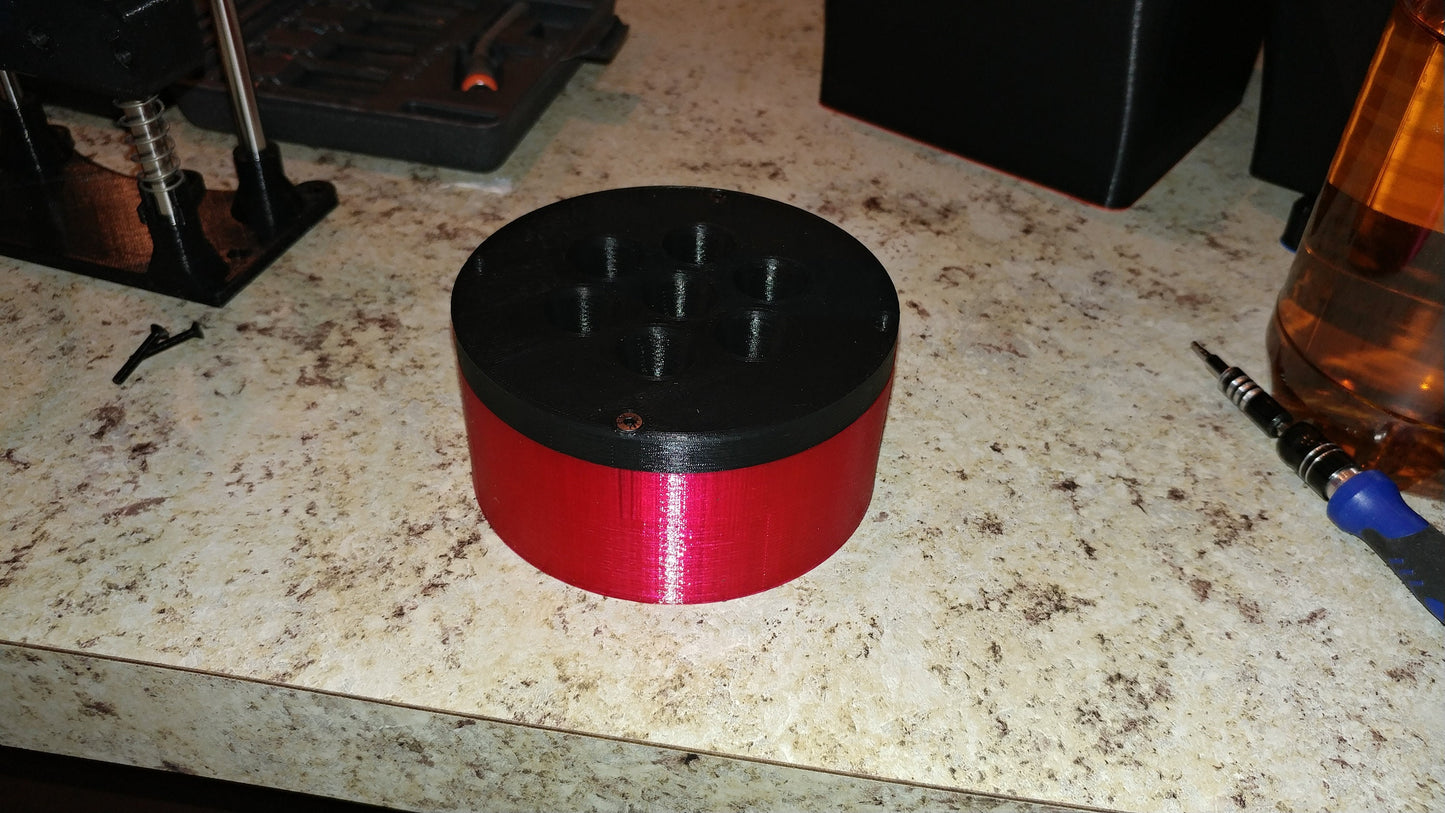 a close up of a red and black object on a counter