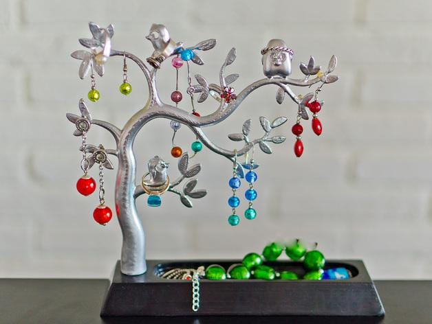 a silver tree with colorful beads on it