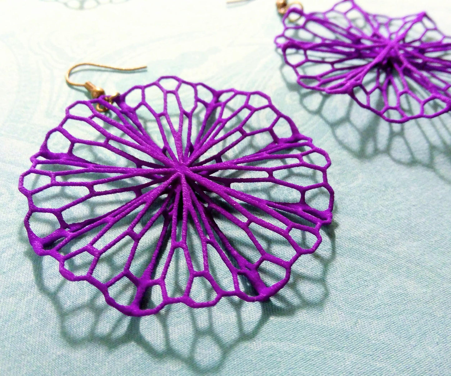 a close up of a pair of purple earrings