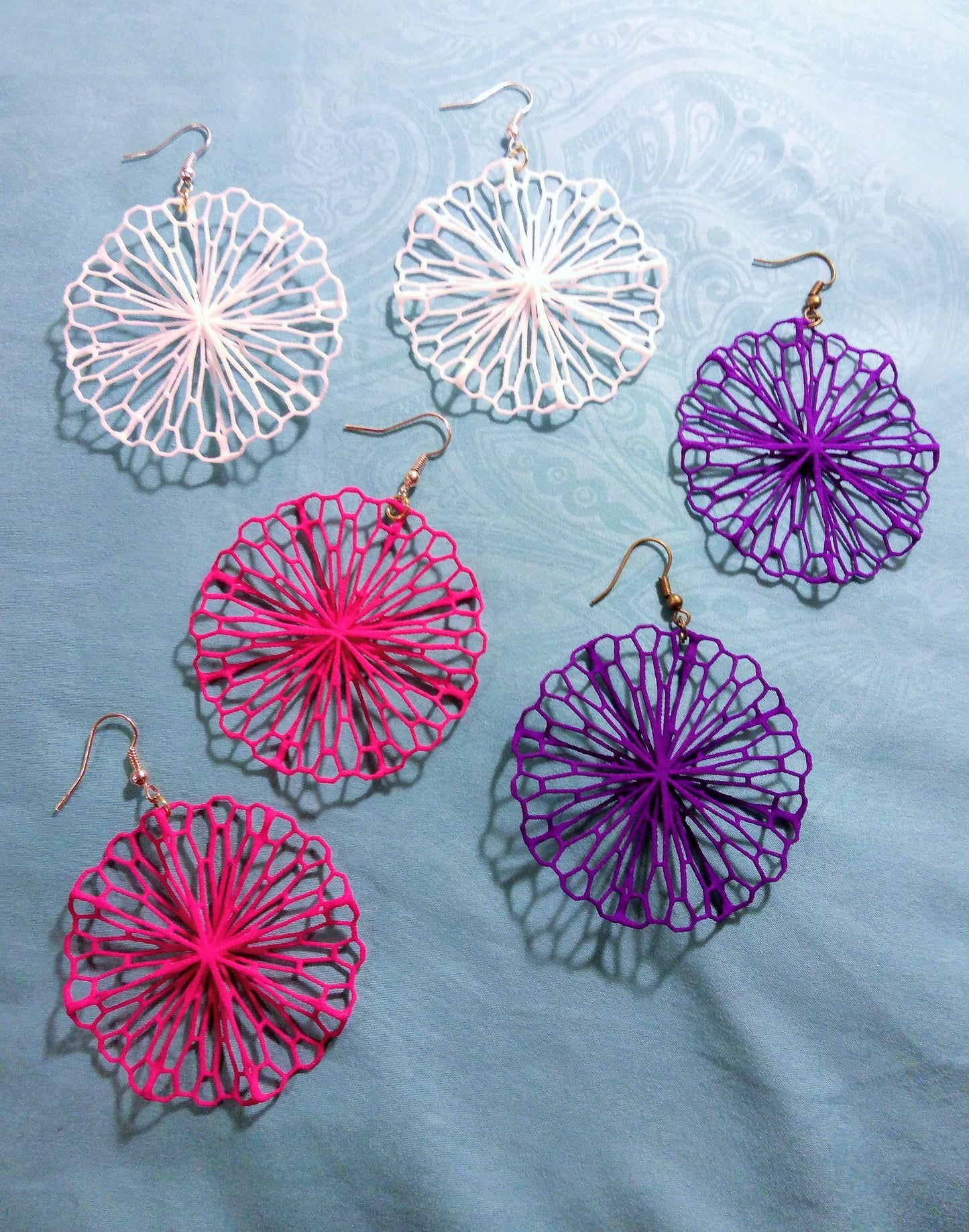 a group of four different colored umbrellas on a table
