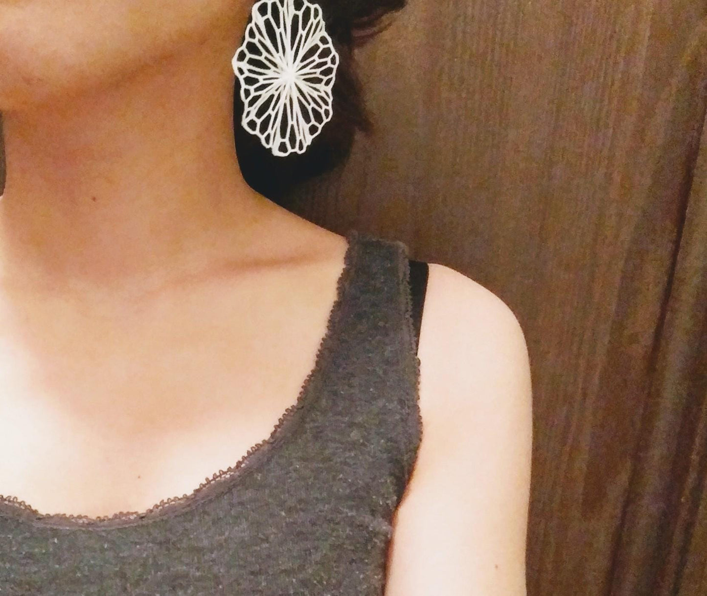 a close up of a person wearing a pair of earrings
