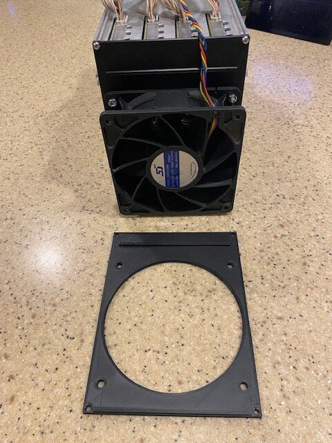 a computer fan is attached to the side of a wall