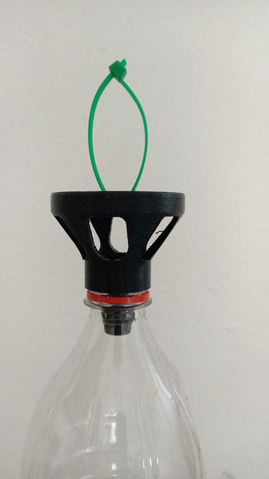 a glass bottle with a green string attached to it