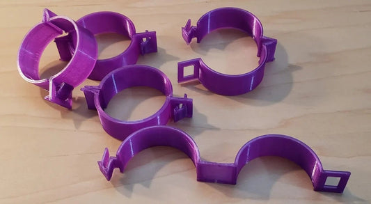 a group of purple plastic rings sitting on top of a wooden table