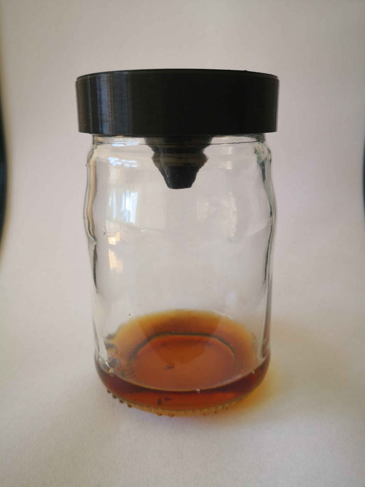 a glass jar filled with liquid sitting on a table