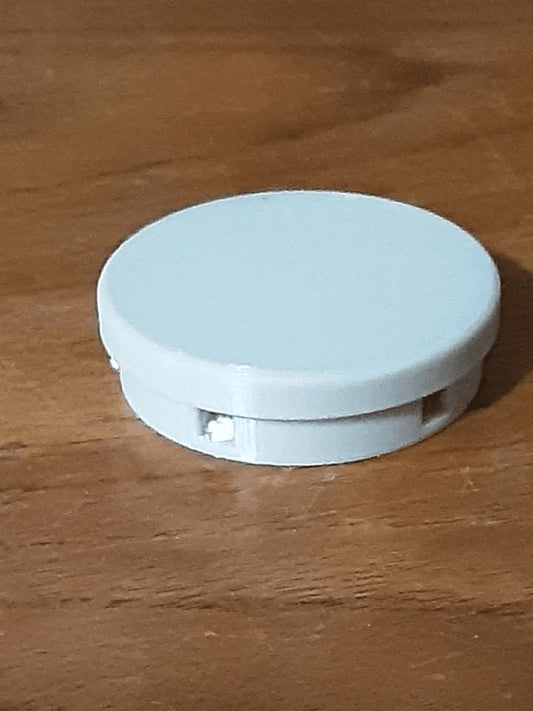 a white object sitting on top of a wooden table