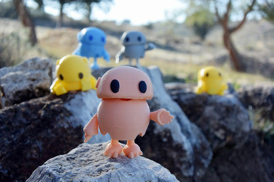 a group of toy figures sitting on top of a rock