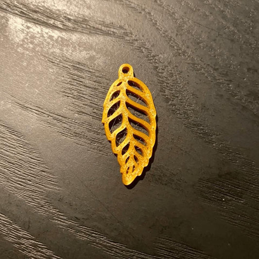 a yellow leaf shaped object sitting on top of a wooden table