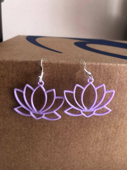 a pair of earrings with a purple flower on it