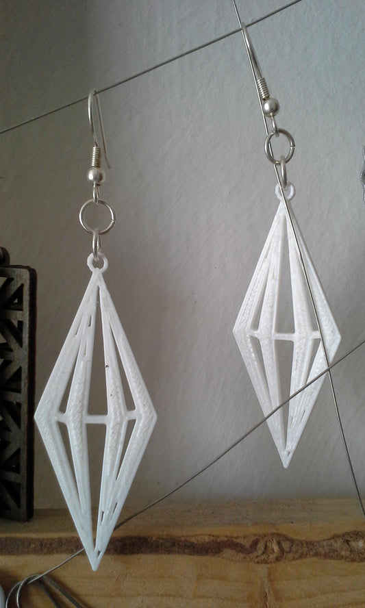 a pair of earrings made out of white paper