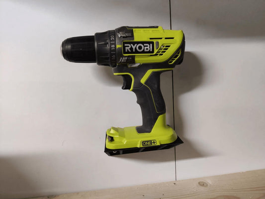 a cordless drill is hanging on a wall